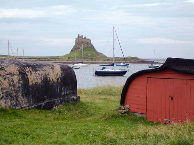 Lindisfarne Castle, harbour and upturned boats | The Old Granary, Holy Island, near Berwick-upon-Tweed