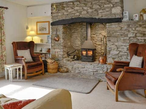 Comfortable living room with a cosy wood burner | Ashley Cottage, Combe Martin, near Ilfracombe