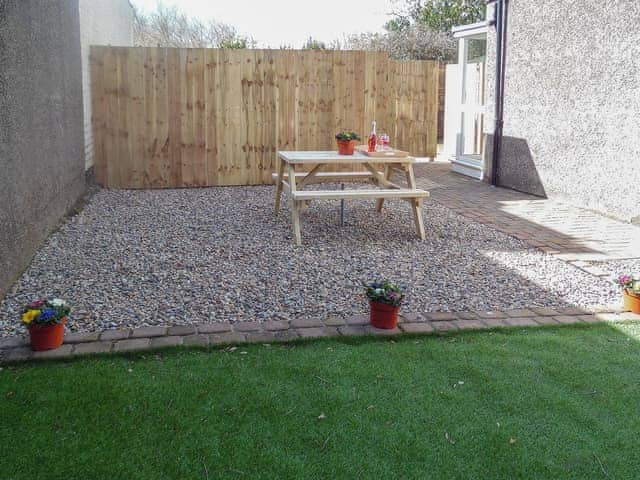 Courtyard-style garden space with picnic table | Robins Nest, Broomhill, near Amble