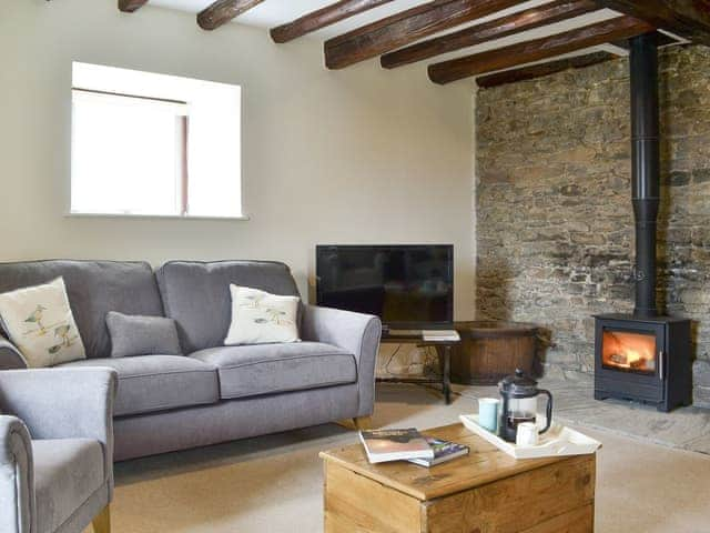 Inviting living area with wood burner | The Old Granary, Holy Island, near Berwick-upon-Tweed