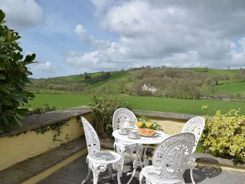 Wonderful terrace with metal furniture | Lower Mill Barn - Pantgwyn Farm Cottages, White Mill, near Carmarthen