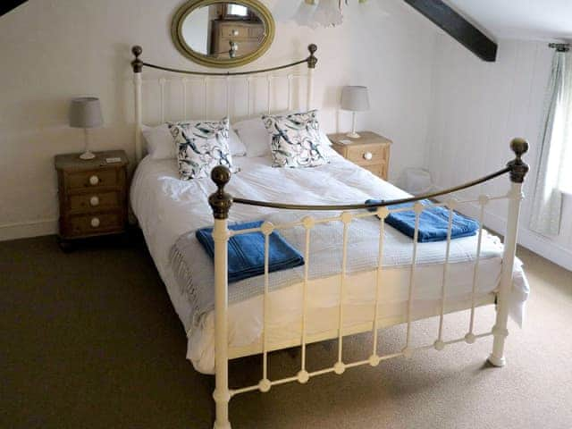 Romantic double bedroom with exposed beams | Jenny&rsquo;s Cottage, Mundesley