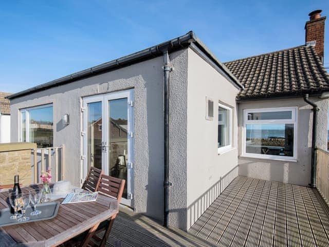 Relaxing seating area outside on the rear decking | The Beach House, Beadnell, near Seahouses