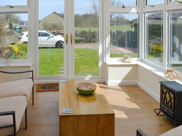 Cosy conservatory with French doors to garden | The Old Parish Hall, Seahouses, near Alnwick