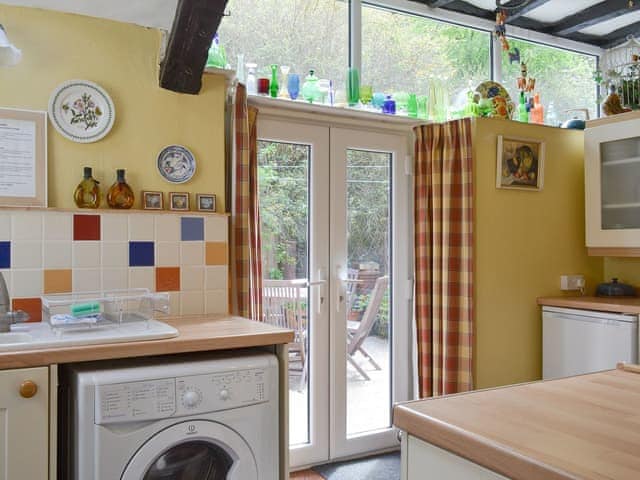 French doors from kitchen lead to patio and garden | Tom&rsquo;s Cottage, Dalton-in-Furness