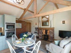 Open plan living with multi-fuel burner and wood beams | Daisy - Ham Hall Lane Cottages, Scruton, near Northallerton
