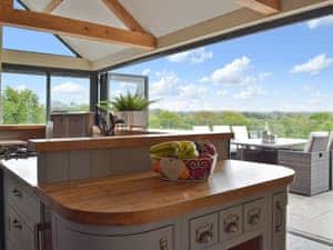 Kitchen with bi-folding doors leading to outdoor dining area | Trecift, Llangoedmor, near Cardigan
