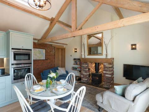 Open plan living with multi-fuel burner & wood beams | Daisy - Ham Hall Lane Cottages, Scruton, near Northallerton