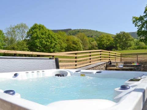 Luxurious hot tub within the rear patio area | Bryn Salem - Cewydd Cottages, Cwm-Cewydd, near Machynlleth