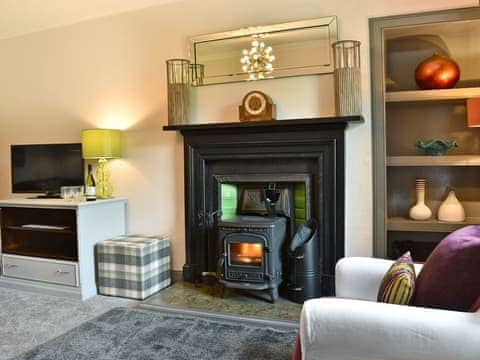 Stylishly furnished living room with wood burner | 2 Northbank Cottages, Whiting Bay, Isle of Arran