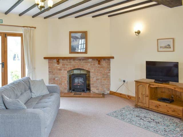 Characterful living room with beamed ceiling | Sawmill Cottage - The Old Timberyard, Puncknowle, near Dorchester