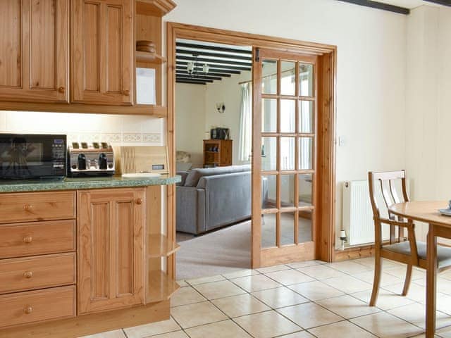 Living room adjoins the kitchen/diner | Sawmill Cottage - The Old Timberyard, Puncknowle, near Dorchester