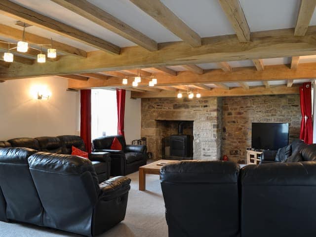 Living room with beamed ceiling and wood burner | The Farmhouse - Bowlees Holiday Cottages, Wolsingham, near Stanhope