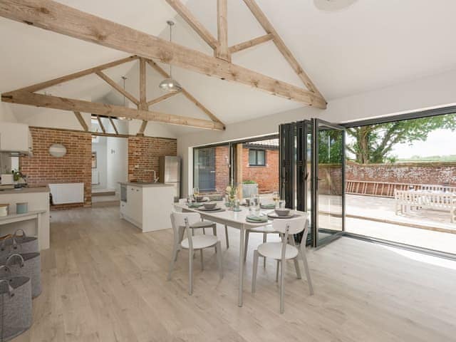 Contemporary living space with bi-fold doors | The Cowshed, Reepham