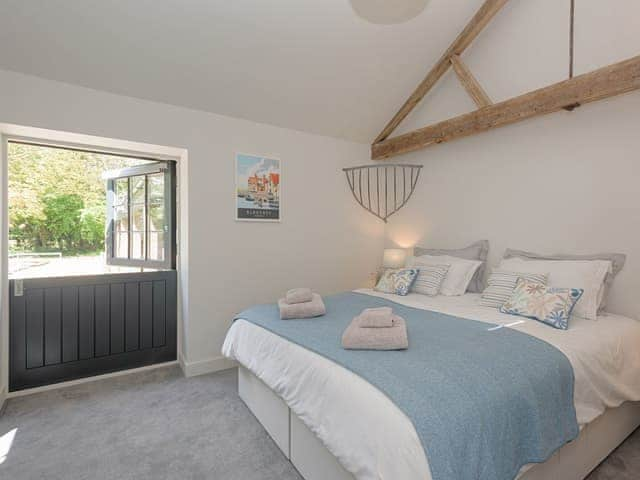 Comfortable second en-suite double bedroom with door to enclosed patio | The Cowshed, Reepham