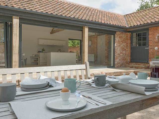 Outdoor dining furniture on patio | The Cowshed, Reepham