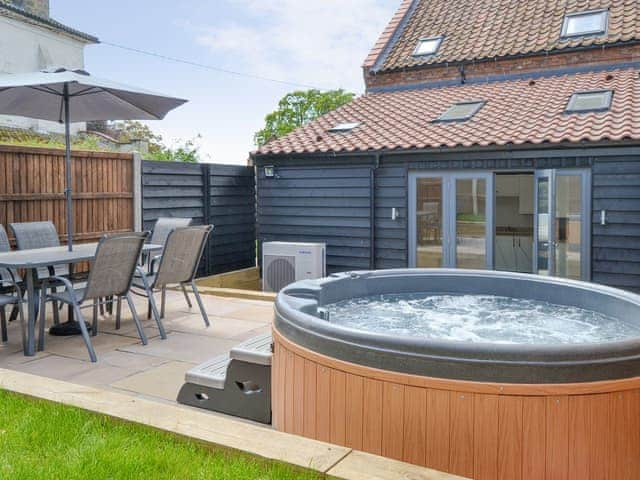 Enclosed rear garden with hot tub | The Old Stables - Swafield Barns, Swafield, near North Walsham