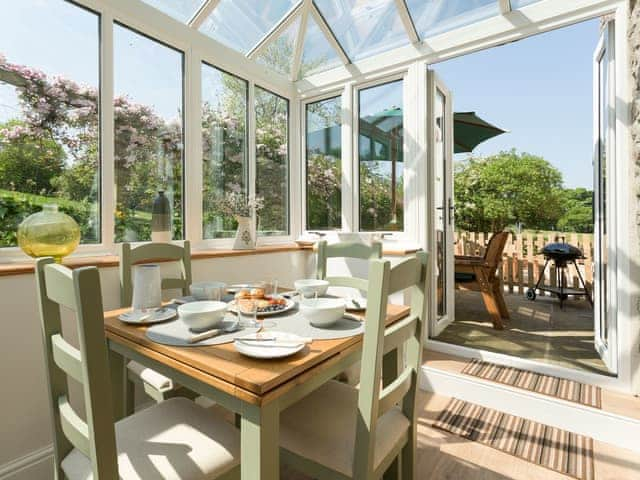 Dining area within conservatory with access to patio area | The Barn - Oak Tree Farm, West Witton, near Leyburn