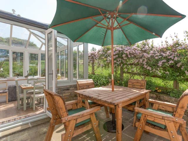 Paved patio with outdoor furniture and BBQ | The Barn - Oak Tree Farm, West Witton, near Leyburn