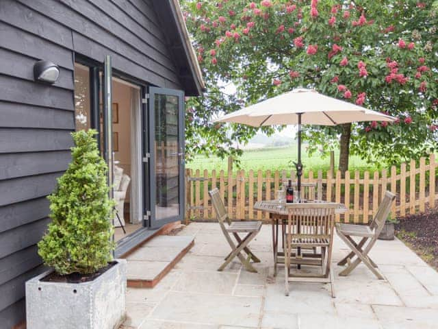 Paved patio with outdoor furniture | The Dairy - Beauworth Cottages, Beauworth, near Alresford