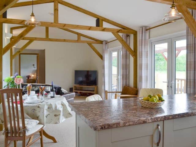 Exposed wooden trusses throughout the living space | Cedar Lodge, Cowbeech, near Hailsham