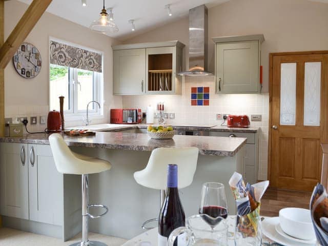 Well-equipped kitchen with breakfast bar | Cedar Lodge, Cowbeech, near Hailsham