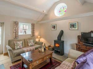 Warm and welcoming living room with cosy wood burner | Walkmill Lodge, Norbury, near Bishop&rsquo;s Castle 