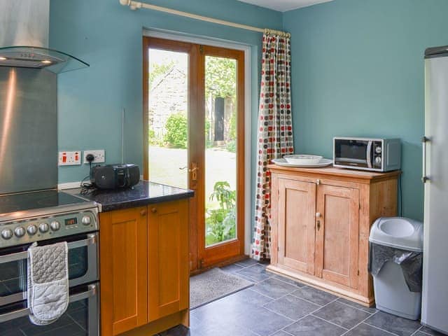 Kitchen with double doors to the garden | Fallodon Burnhouses, near Beadnell