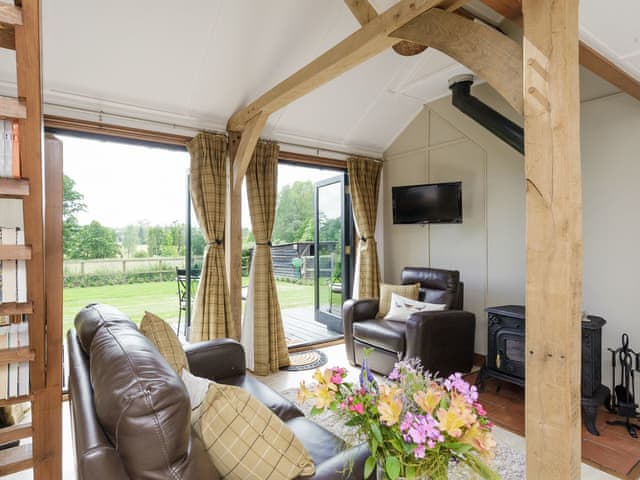 Welcoming living area with exposed wooden frame | Toad Hall Cottage, White Colne, near Colchester