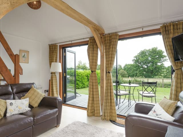 Double French doors open onto the decked patio | Toad Hall Cottage, White Colne, near Colchester