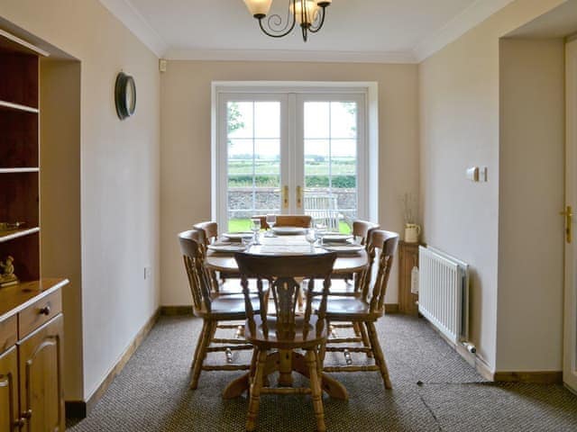 Light and airy dining area with French doors to garden | Holmlea, Newtown, near Silloth