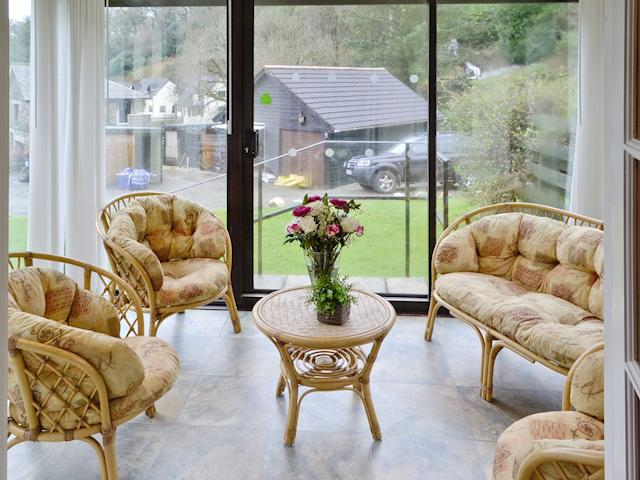 Comfortable seating in conservatory | Riverside Cottage - Rosecraddoc Manor, Liskeard