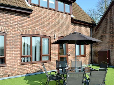 Exterior with siting out area | Villa 55, Cromer