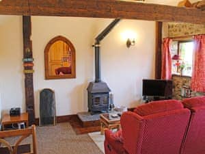 Living room with wood burner | Whitwell Farm CottagesBrandy&rsquo;s, Whitwell Farm, Colyford, near Seaton