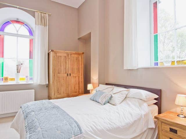 Charming double bedroom with high ceiling and stained glass windows | Dales Chapel, Middleton-in-Teesdale