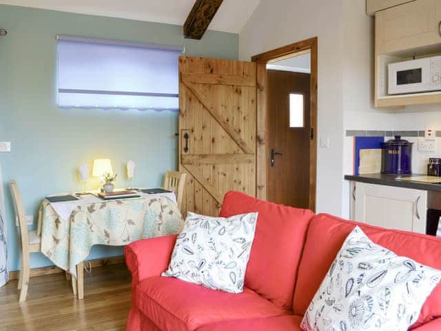 Convenient dining area and exposed carved wooden beams | Shepherdskirk - Wide Sky Cottages, Lowick, near Berwick-on-Tweed