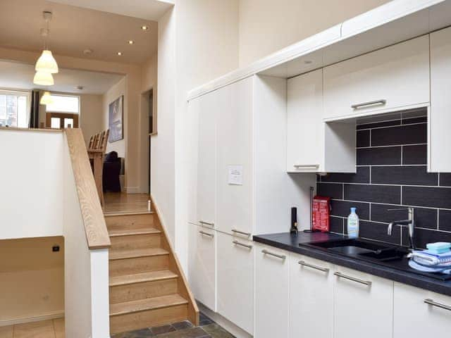 Fitted kitchen with stairs down to lower level | Falcon Crag, Keswick