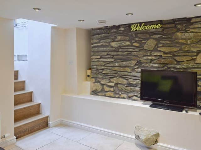 TV lounge with exposed stone feature wall | Falcon Crag, Keswick