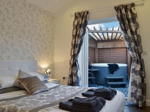Double bedroom to hot tub | Oswald Lodge, Llanon, nr. Aberystwyth