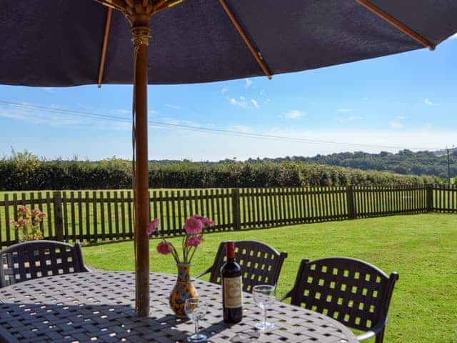 Sitting out area with countryside views | Saunders Oast Barn, Guestling, near Hastings