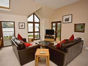 Large open plan living area with patio doors onto the balcony | The Quaich, Fearnan, by Aberfeldy