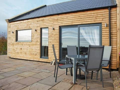 Patio area of timber-clad property with private outdoor seating area | Number 3 - The Old Stables, Knitsley, near Lanchester