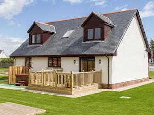 Smart modern chalet-style cottage with terrace and hot tub set in own garden | Seascape - Seascape Cottages, Southerness, near Dumfries