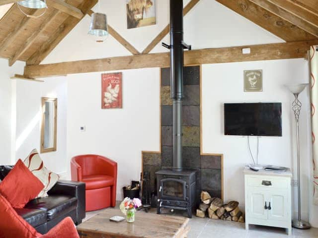 Living area with exposed wooden beams | The Parlour - Milton End Farm Barns, Arlingham, near Frampton-on-Severn