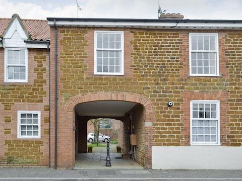 Quirky exterior of property with entrance in archway | Trentham Cottage, Snettisham, near Hunstanton