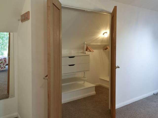 Walk-in wardrobe within master bedroom | The Old Smithy, Penelewey, near Truro