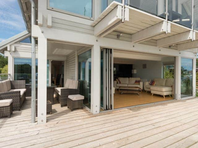 Outdoor furniture on decking and bi-fold doors to living area | Silver Dawn, Horning, near Wroxham