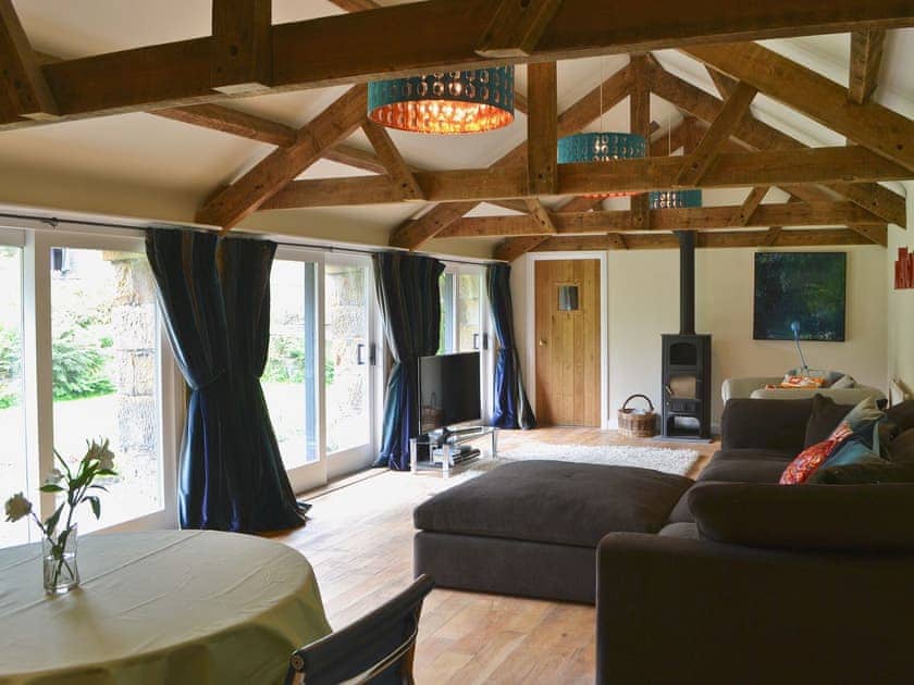 Spacious beamed living room with wood-burning stove | The Carriage House - Bitchfield Tower Cottages, Belsay