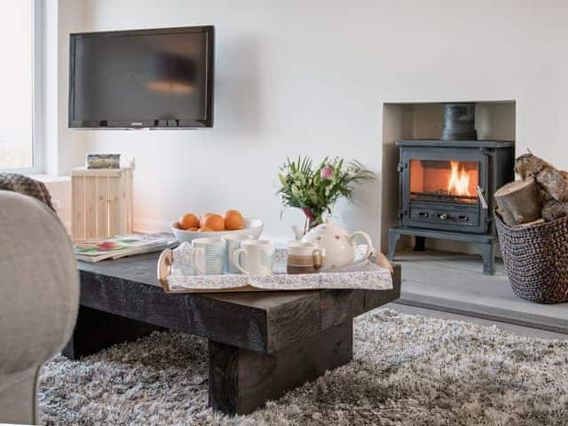 Living area with wood burner | The Beach House, Beadnell, near Seahouses