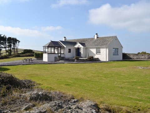 Impressive exterior situated  in a fantastic setting with commanding views of the sea | Bwthyn Pereos, Cemlyn near Amlwch